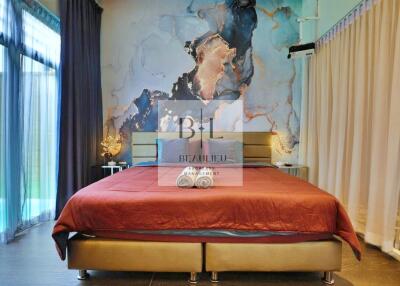 Modern bedroom with large bed and artistic wall decor