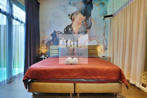 Modern bedroom with large bed and artistic wall decor