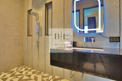 Modern bathroom with a walk-in shower and a sleek vanity