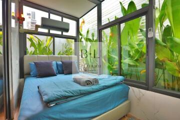 Bedroom with large windows and modern decor