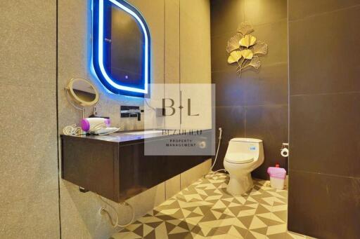 Modern bathroom with illuminated mirror and stylish decor