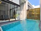 Modern pool area with glass sliding doors and bamboo wall