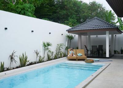 Modern outdoor area with swimming pool and lounge chair