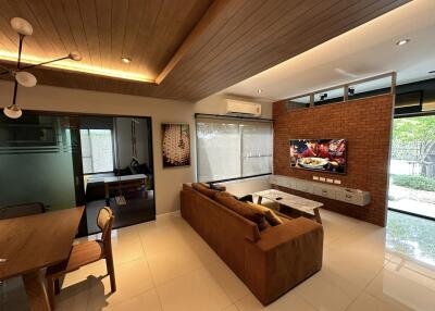 Modern living room with large TV and comfortable seating