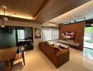 Modern living room with large TV and comfortable seating