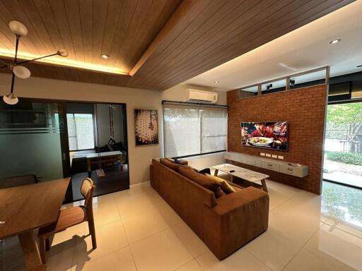 Modern living room with large TV and comfortable seating