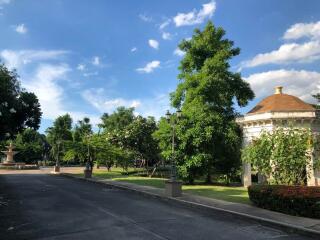 Outdoor view with a park, trees, and a small round building