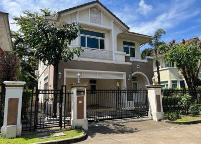 Front view of a two-story house with a gated entrance