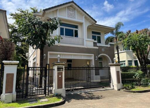 Front view of a two-story house with a gated entrance