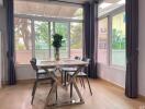 Dining area with glass table and large windows