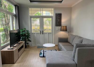 Modern living room with a grey sectional sofa and large window