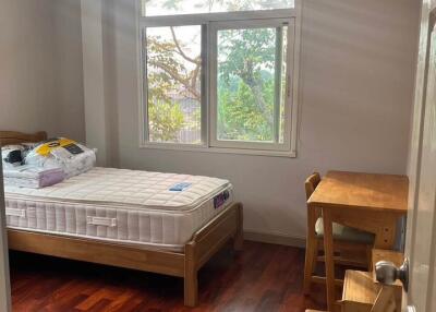 Bedroom with window, bed, and study desk