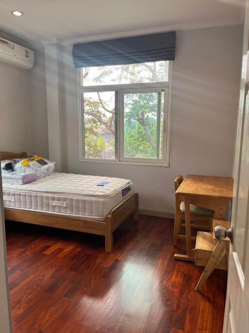 Bedroom with window, bed, and study desk