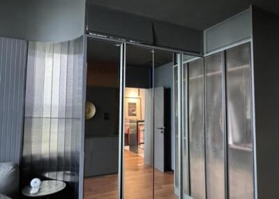 Modern bedroom with wooden floors and mirrored closet