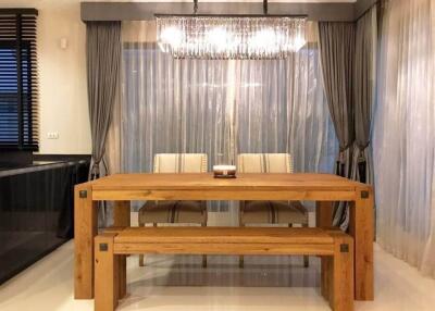 Modern dining room with curtains and chandelier