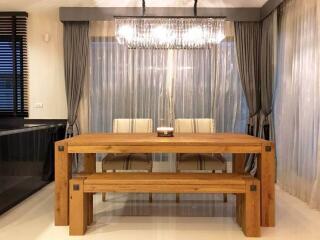 Modern dining room with curtains and chandelier