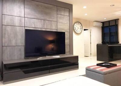 Modern living room with a large flat-screen TV and stylish decor