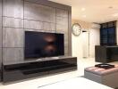 Modern living room with a large flat-screen TV and stylish decor