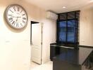 Modern kitchen with large wall clock and black countertops