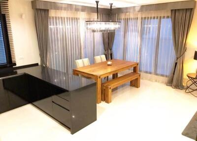 Dining area with wooden table and modern lighting