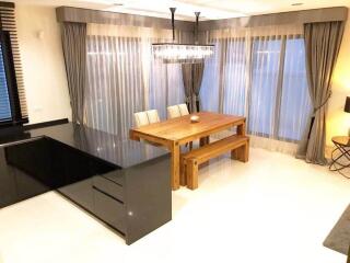 Dining area with wooden table and modern lighting