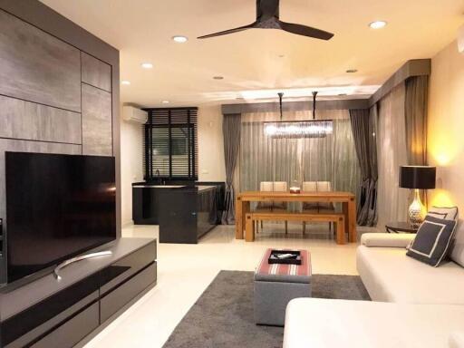 Modern living room with open dining area and kitchen