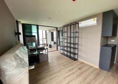 Modern living room with wooden flooring, air conditioning, and floating shelves