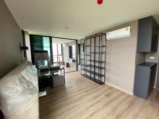 Modern living room with wooden flooring, air conditioning, and floating shelves