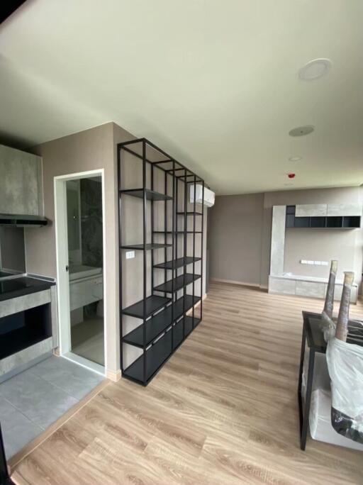 modern living room with shelving and wooden flooring