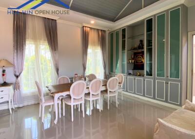 Elegant dining area with large windows and built-in cabinets