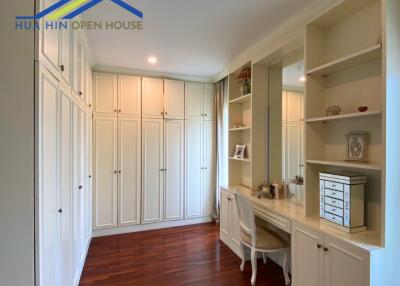 Elegant bedroom with built-in wardrobes and vanity area