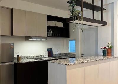 Modern kitchen with granite countertops and hanging shelves