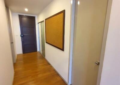 Interior hallway with doors and a bulletin board