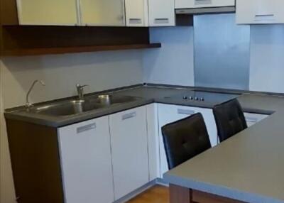 Modern kitchen with sleek countertops and bar stools