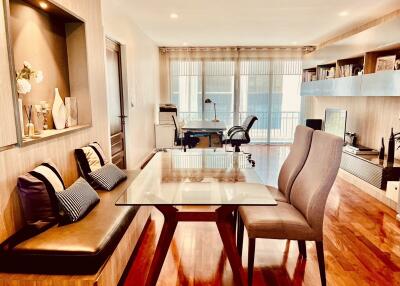 Modern living room area with dining table, seating, and study corner