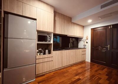 Modern kitchen with wooden cabinetry and stainless steel appliances