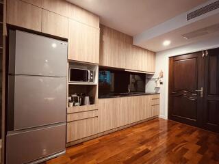 Modern kitchen with wooden cabinetry and stainless steel appliances