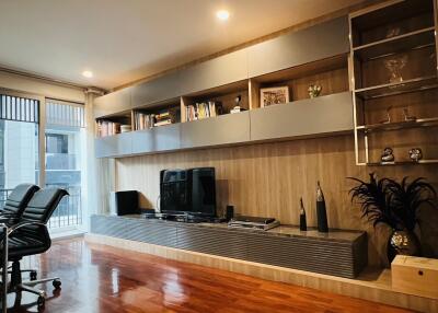 Modern living room with built-in shelving and entertainment center