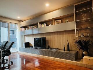 Modern living room with built-in shelving and entertainment center