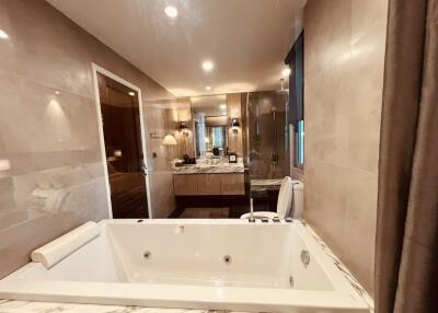 Modern and luxurious bathroom with a large marble jacuzzi tub and stylish fixtures