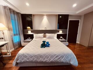 Spacious modern bedroom with king-size bed and decorative pillows