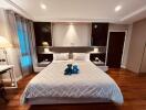 Spacious modern bedroom with king-size bed and decorative pillows