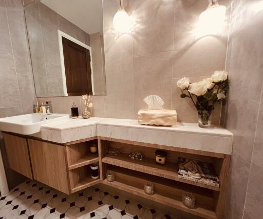 Modern bathroom with illuminated vanity and flowers