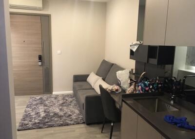 Main living area with a sofa and kitchenette