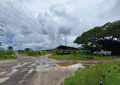 Rural landscape with muddy road and parked vehicle