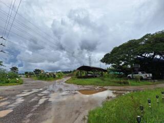 Rural landscape with muddy road and parked vehicle