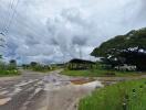 Rural landscape with muddy road and parked vehicle