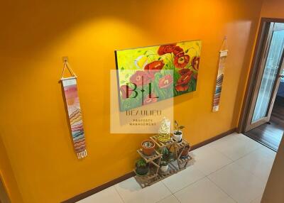 Colorful hallway with plants and wall decor