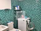 Bathroom with washing machine and green mosaic tiles