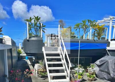 Stylish outdoor terrace with stairs, potted plants, and seating area